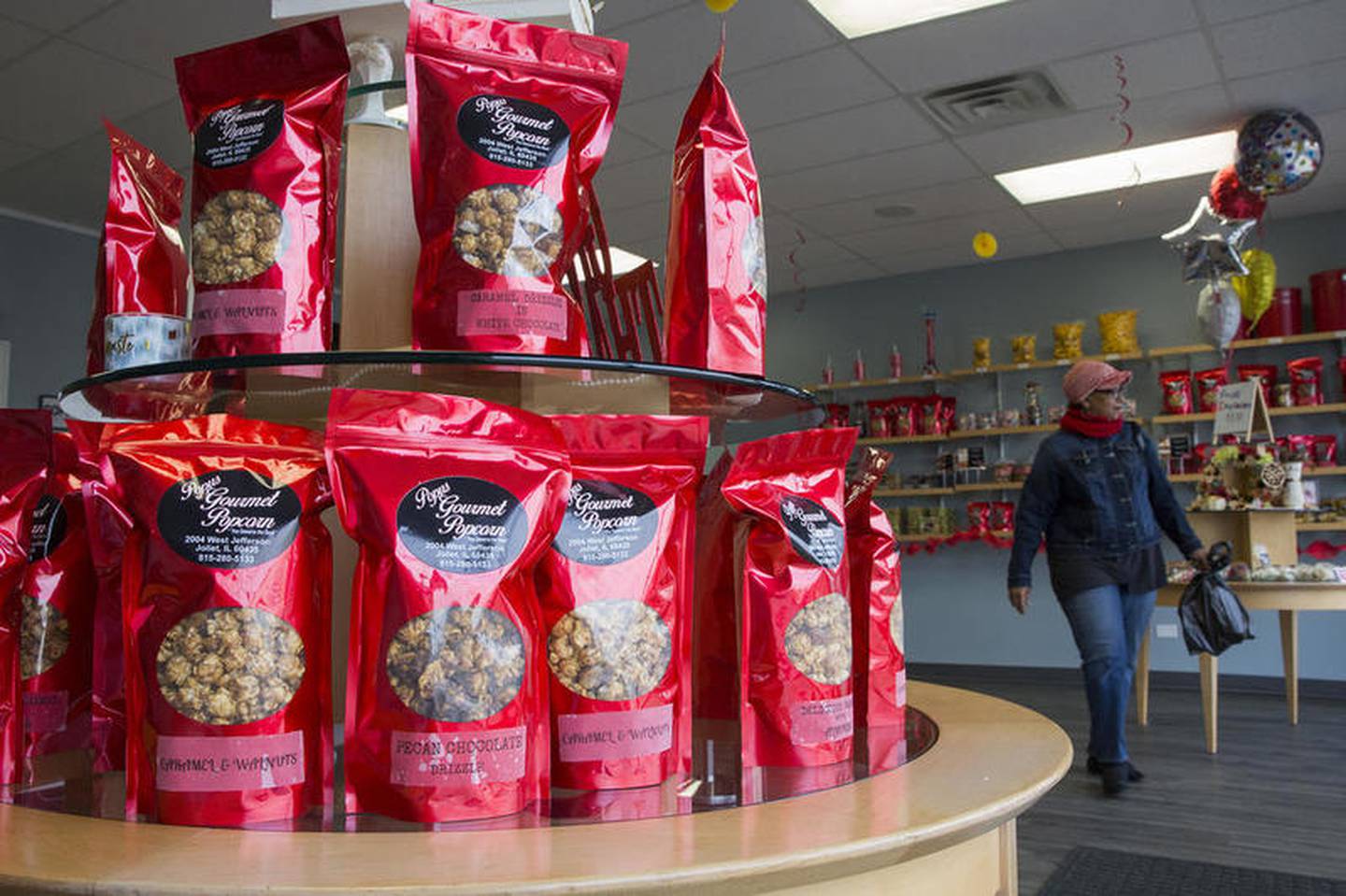 Customers file in and out of Popus Gourmet Popcorn with Thanksgiving treats on Wednesday, Nov. 21, 2018, at Popus Gourmet Popcorn, in Joliet, Ill. Popus Gourmet Popcorn is one of the thousands of business across the nation participating is Small Business Saturday, an annual shopping holiday designed to celebrate and help discover small businesses.